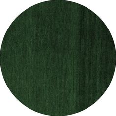 a round green rug on a white background