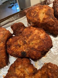 some fried food is sitting on a piece of tin foil and ready to be cooked