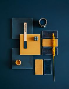 a blue table with yellow and blue tiles, a cup of coffee and a feather on it