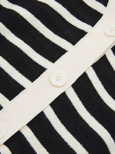 MO&Co. Women's Short Sleeve Contrast Cardigan This classic black and white striped cardigan features a stylish v-neck and puff sleeves. The front is decorated with a row of beautiful buttons, making it a fashionable piece that can be styled for any occasion. Features : - Classic black and white stripes- Puff sleeve and short sleeves- V-neck with buttons along the front Code: MBC2CAR011The back length of size S is 51.5cmMATERIALS & CARE Material: 82.7% Cotton 17.3% PolyamideOur sizes might be a l