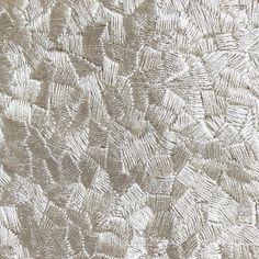 closeup of an embroidered fabric textured with white thread