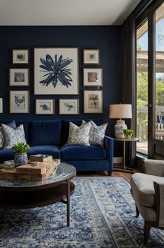 a living room with blue couches and pictures on the wall above them, along with a coffee table