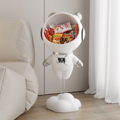 a white robot holding a bunch of snacks