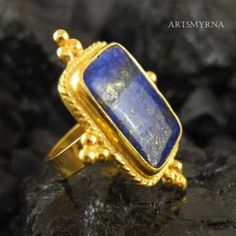 ARTSMYRNA METAL: 925k Silver GEM: Lapis COATING: 24k gold over (We can made a special type of coating for your personal preference ) MATERIEL : 925K Sterling Silver ( Some of my items vermeil gold over silver for looks rich . But i can finish in silver too ) PAYMENT : We accept paypal payment RING SIZE: 6 (your desired size is made) GEM FEATURES AND BENEFITS Benefit: Strengthens physical abilities and communication ability. Properties: Lapis lazuli stone has been used as an ornament and jewelry Ancient Roman Art, Silver Bridesmaid, River Edge, How To Look Rich, Lapis Lazuli Ring, Bee Pendant, Silver Signet Ring, Roman Art, Lapis Lazuli Stone