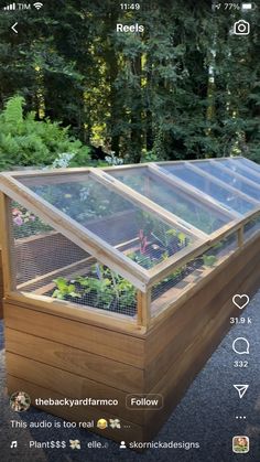 a wooden box with plants growing inside it