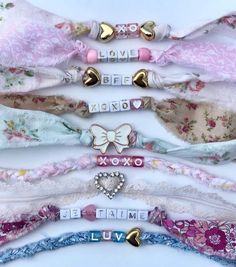 several different types of headbands with bows and hearts on them in various colors