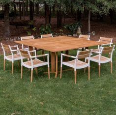 a wooden table and chairs sitting in the grass