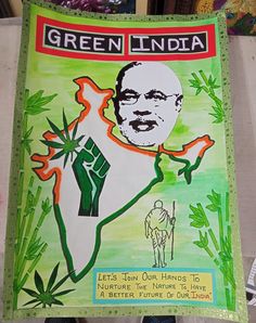 a green india poster hanging on the wall