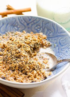 a bowl filled with oatmeal and granola on top of a table