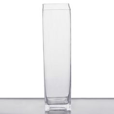 a tall glass vase sitting on top of a table