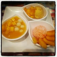 three bowls filled with different types of food on top of a white plate, next to each other