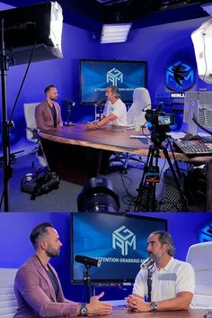 two men are sitting at a table with microphones in front of them and one man is talking to the camera