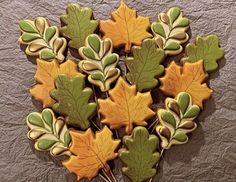 cookies decorated with leaves and acorns are arranged in the shape of a heart