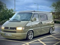 a green van parked in a parking lot