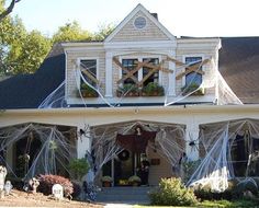 a large white house with halloween decorations on the front