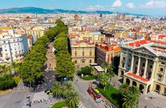 an aerial view of a city with many buildings and trees in the foreground,