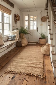 a room with wooden floors, white walls and wood flooring is decorated in natural materials