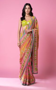 Editor's Note Sunset Orange Ombre Hand Embroidered Sari With Tone on Tone SB Signature Floral Print and Hand Embroidered Contrast Border Paired with Hamsa Details and Pastel Parrot Green Sequence Blouse. Fabric: Pure Crepe, Georgette Sequence Color: Orange Care: Dry Clean Only Disclaimer: Product Color May Slightly Vary Due To Photographic Lighting Sources Or Your Monitor Setting. About the Designer Siddhartha Bansal, label epitomise its design philosophy touring around " Golden bird" nation to Siddhartha Bansal, Phulkari Saree, Leaf Sleeve, Floral Print Sarees, Parrot Green, Orange Saree, Print Saree, Saree Designs Party Wear, Indian Dresses Traditional