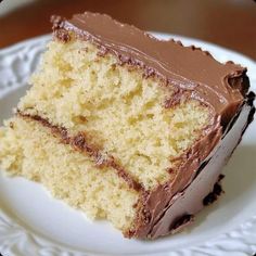 a piece of cake on a plate with chocolate frosting