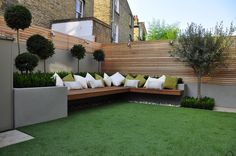 an outdoor seating area with grass and trees