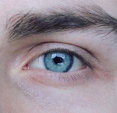 a man's blue eye is seen in this close up photo