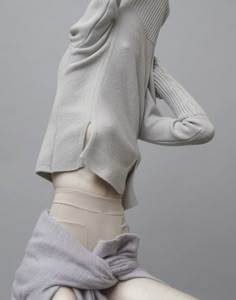 the back of a mannequin's head wearing a sweater and skirt