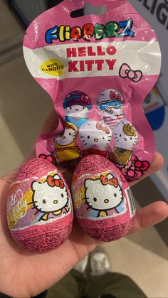 hello kitty chocolate eggs are being held by someone