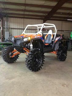 an orange and black atv parked in a garage