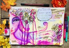 an art journal with flowers and music notes on the page, surrounded by autumn leaves