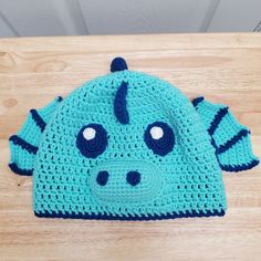 a blue crocheted hat with horns on it