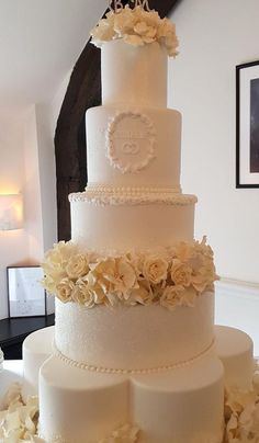 a large white wedding cake with flowers on it