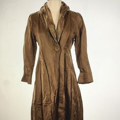 Eileen Fisher Metallic Gold Trench Coat/Fashion Coat Is Nwot! Truly The Most Exquisite Coat I’ve Ever Listed. It's Listed As A Trench Coat, But It's So Much More. It's So Very Elegant. Crinkled Gold Metallic Fabric With Shawl Collar And 3/4 Sleeve. Single Button Closure. Falls Just Below The Knee. 60% Cotton; 30% Nylon; 10% Metallic. Gorgeous Gold Netting At The Bottom; The Fit Is Fabulous! Size Extra Small: 39 Inches From Nape Of Neck To Bottom Hem; 17 Inches Across The Bust Line; 20 Inch Sleev Classic Gold Outerwear With Double-breasted Buttons, Gold Double-breasted Outerwear With Buttons, Gold Single-breasted Winter Outerwear, Vintage Brown Single-breasted Classic Outerwear, Vintage Brown Single-breasted Long Sleeve Outerwear, Trench Coat Style, Nape Of Neck, Metallic Fabric, Eileen Fisher