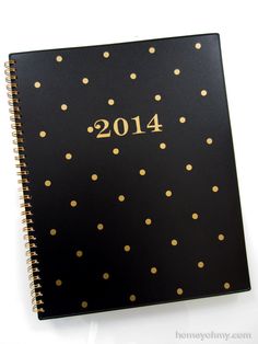 a black and gold dotted notebook with the year 2014 written in gold foil on it