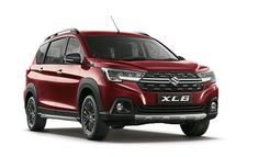 a red suv parked in front of a white background with the words xel on it