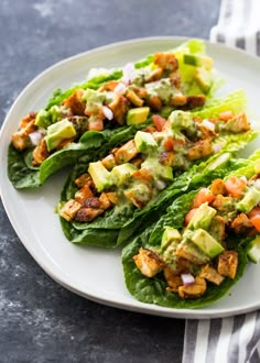 lettuce wraps with chicken and avocado dressing on a white platter