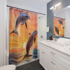 a bathroom with two dolphins on the shower curtain