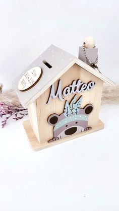 a wooden birdhouse with the word mother written on it