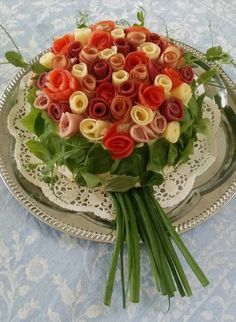 a bouquet of flowers sitting on top of a silver plate