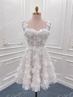 a dress made out of white feathers on a mannequin