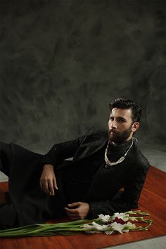 A black sherwani detailed with all over patterns incorporating sequins and a hand embellished band.

Fabric: Jamawar
Color: Black