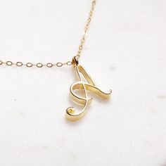 A Initial Necklace - Timeless cursive "A" initial gold pendant - Personalized, Monogram jewelry for women - Vintage inspired font. Delicate "A" initial. Perfect every day necklace. Lovely gift for your self, sister, bridesmaids, new mom. Pendant: Base metal is brass and 14K gold plated. Chain is 18 inches, 14k gold filled. Note: model shots might show a different initial, only to illustrate overall look and length of the chain. This listing is for the "A" initial. Alphabet Necklace Initials, Letters Cursive, Letter Necklace Gold, Wedding Minimalist, Alphabet Necklace, Dainty Diamond Necklace, Gold Letter Necklace, Jewelry Clothing, Initial Necklace Gold