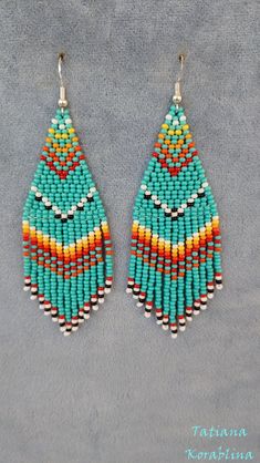 a pair of earrings made from seed beads on a gray background with the words, tatting