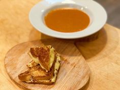 grilled cheese and tomato soup on a wooden plate