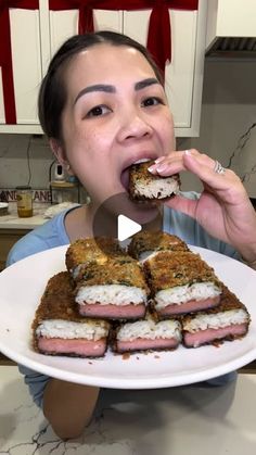 a woman holding a plate with food on it in front of her face and making a funny face