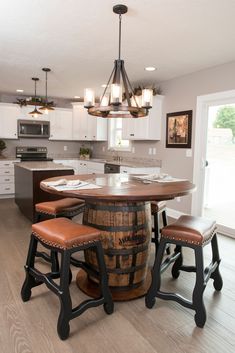 a kitchen with an island and stools in it