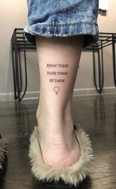 a person with a tattoo on their foot that says know them raise them by them