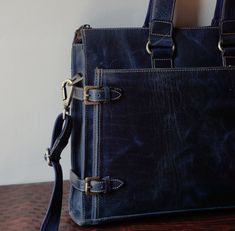 Elevate your style and protect your essentials with our Vintage Two-Tone Blue Handmade Leather Laptop Bag for Men. Crafted with precision and attention to detail, this bag is not just a practical accessory; it's a statement of sophistication. Made from genuine leather, this laptop bag features a unique two-tone blue design that adds a touch of vintage charm. The handcrafted construction ensures that it's not only stylish but also built to last. With ample space for your laptop, documents, and personal items, this bag is the perfect companion for your workday, business meetings, or casual outings. The adjustable shoulder strap provides comfort and convenience, making it a versatile addition to your wardrobe. Embrace the blend of classic and contemporary design, and make a lasting impression Luxury Waxed Finish Briefcase For Everyday, Luxury Briefcase With Waxed Finish, Luxury Satchel With Waxed Finish For Daily Use, Luxury Daily Use Satchel With Waxed Finish, Blue Leather Briefcase For Business, Blue Briefcase For Daily Use, Modern Waxed Finish Briefcase For Everyday Use, Blue Leather Rectangular Satchel, Blue Satchel Briefcase For Everyday Use