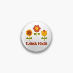 a button with flowers on it that says flower power in red and yellow letters, against a white background