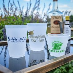 three plastic cups sitting on top of a table