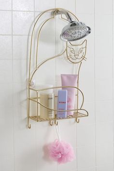 a shower caddy with soap, shampoo and lotion on it in a white tiled bathroom